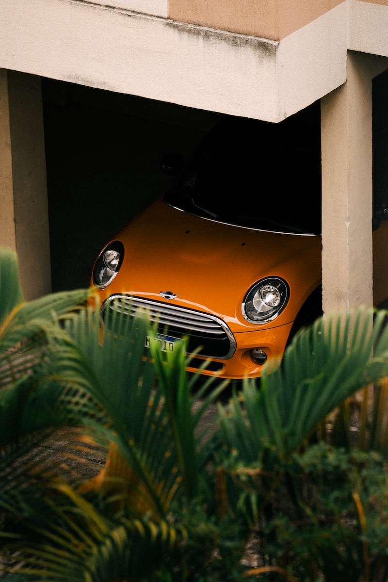 an orange car is parked in a garage